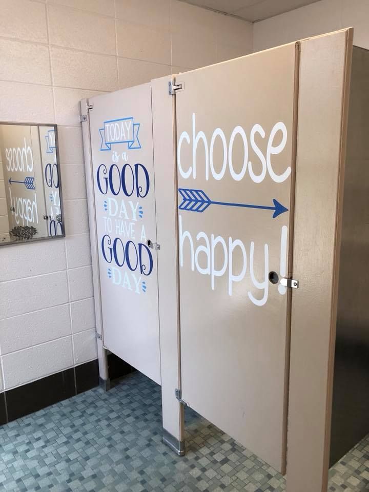Picture of school bathroom stalls utilizing vinyl decals to display positive messages to encourage good behavior and positive self esteem among students. 
